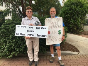 Two members of Neighbors for Peace, stand outside the courthouse.